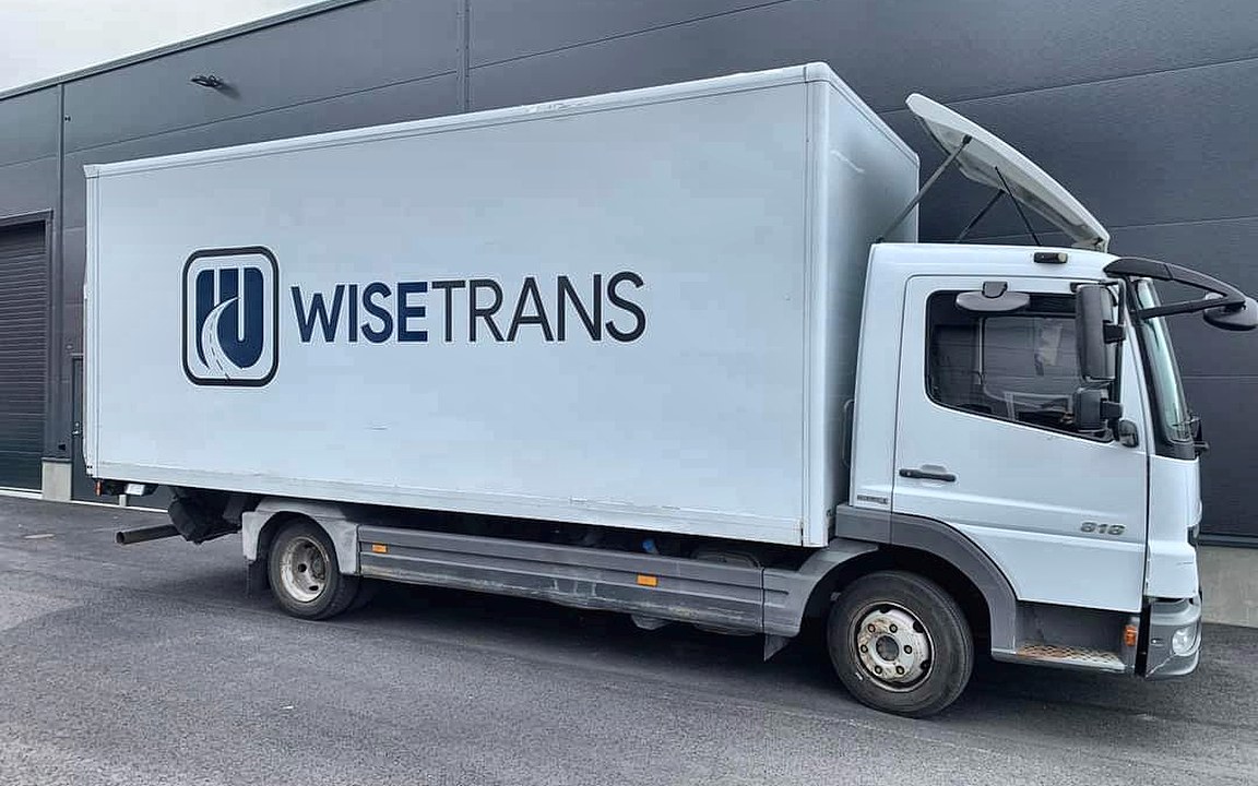 WiseTrans truck in front of a warehouse